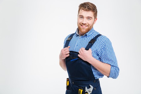 Portrait of a handsome male builder standing isolated on a white background and looking at cameraの写真素材