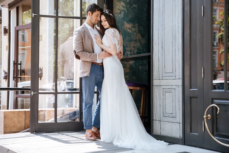 Full length portrait of modern tender young couple of groom and brideの写真素材
