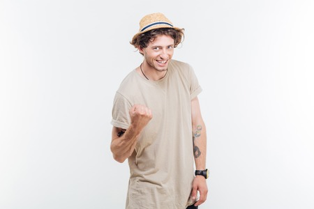 Handsome casual young man showing excitement isolated on white backgroundの写真素材