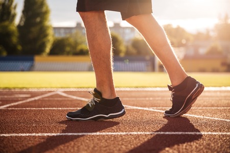 Cropped image of a sprinter getting ready to start at the stadiumの写真素材