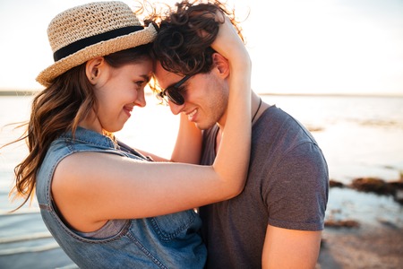 Closeup of happy beautiful young couple on the beachの写真素材