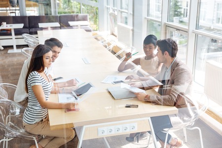 Multiethnic group of young business people on the meeting in conference roomの写真素材