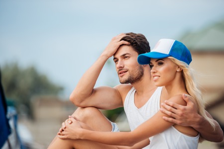 Younh happy smiling couple in love hugging outdoorsの写真素材