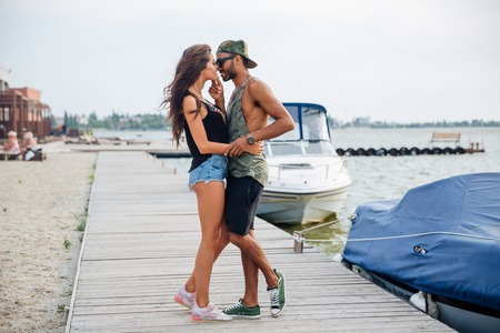 Happy young couple in love kissing at the wooden sea pierの写真素材
