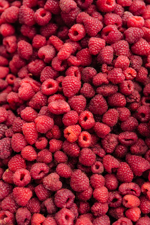Close-up view of a heap of fresh juicy raspberries