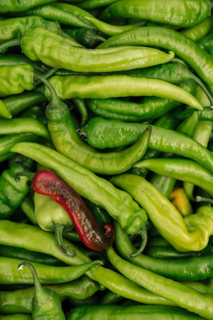 Pile of spicy green and red hot chili peppersの写真素材