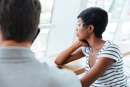 Two young colleagues having coffee break together at cafeの写真素材