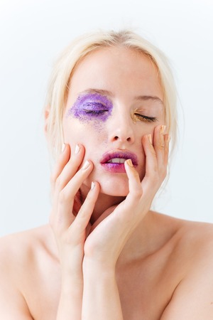 Beauty portrait of tender young woman with stylish makeup and closed eyes over white backgroundの写真素材