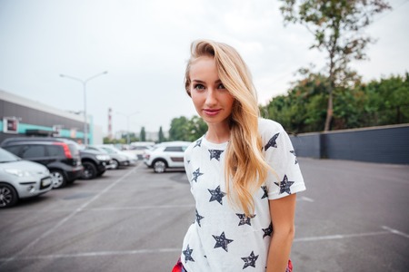 Portrait of a beautiful cheerful young woman outdoorsの写真素材