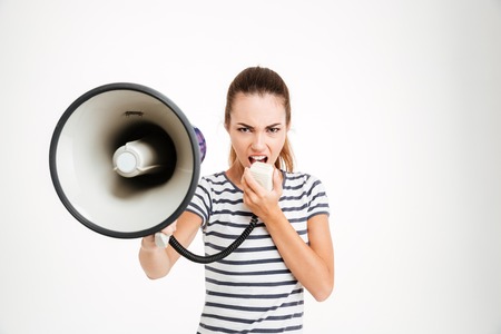 Beautiful woman shouting into megaphone isolated on a white backgroundの写真素材