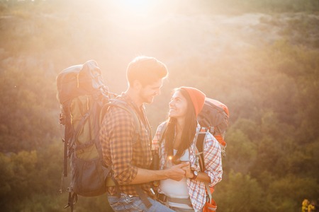 Two young tourists on slope. sunny. eyes to eyesの写真素材