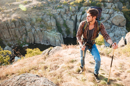 Traveler with backpack stands near the canyon. looking away. full length imageの写真素材