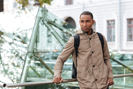 Picture of young african man standing in the street and look aside.の写真素材