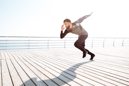 Runner starts near the sea. full length image. side viewの写真素材