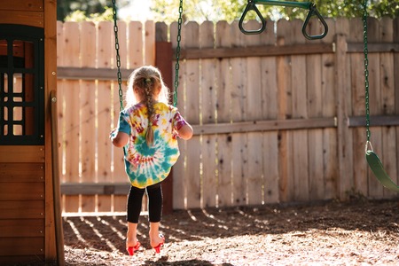 Back view of girl on swing. full length imageの写真素材