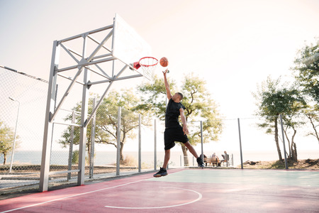 Photo of basketball player practicing and posing for basketball and sports athlete concept. Looking...