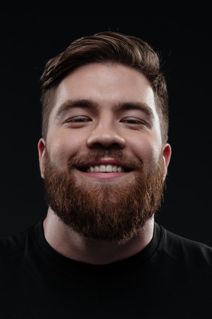 Close up trainer. smiling man in studio. isolated dark bavkground