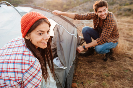 Young active couple setting up a tent outdoorsの写真素材