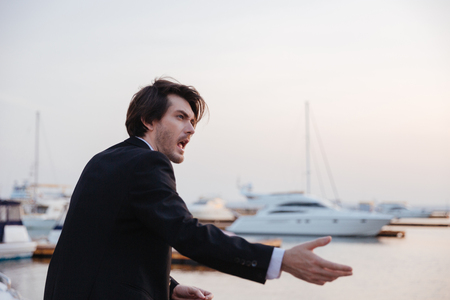 Emotional man in suit. in port. looking awayの写真素材