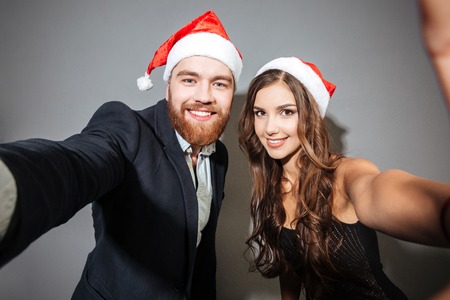 Christmas couple make selfie. looking at camera. Close up portraitの写真素材