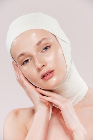 Unusual photo of model. looking at camera. in studio. isolated pink backgroundの写真素材