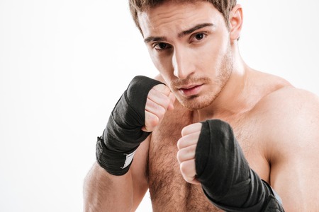 Image of handsome young man boxer standing over white background. Look at camera.の写真素材