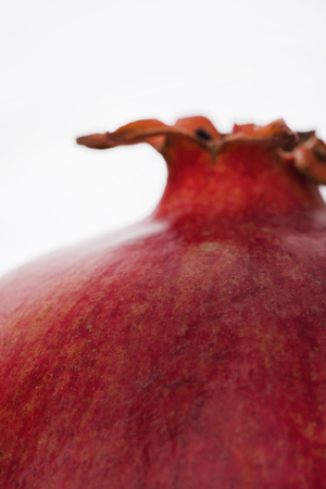 Cropped image of a pomegranate isolated on white backgroundの写真素材