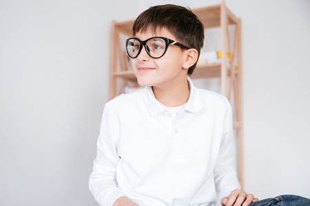 Portrait of smiling little boy in white shirt in glassesの写真素材