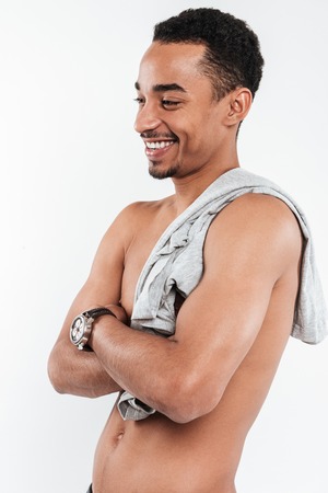 Photo of happy african man posing over white background and looking aside.の写真素材