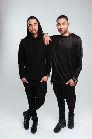 Full length of two confident african american young men standing togetherの写真素材