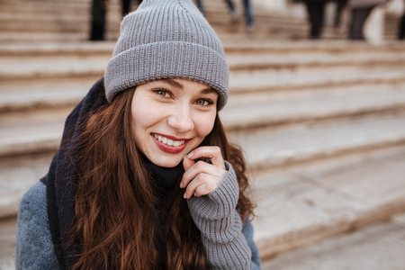 Portrait of happy beautiful young woman on the street in autumnの写真素材