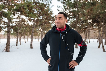 Young afro american man taking a break while doing winter fitness sessionの写真素材