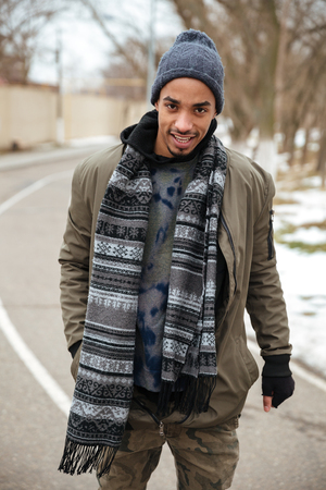 Confident african american young man standing on the road in winterの写真素材