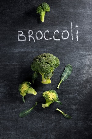 Top view photo of broccoli over dark chalkboard background.の写真素材