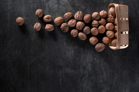 Top view image of a lot of walnuts over dark backgroundの写真素材