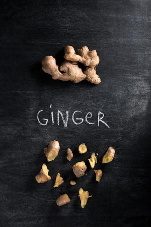 Top view photo of a ginger over dark chalkboard backgroundの写真素材