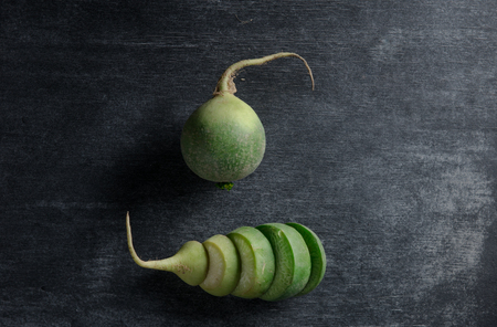 Top view photo of the cut radish over dark backgroundの写真素材
