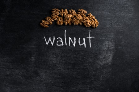 Top view picture of walnut over dark chalkboard backgroundの写真素材