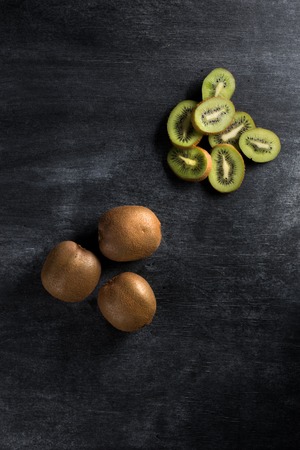 Top view photo of kiwi over dark chalkboard backgroundの写真素材