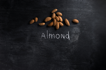 Top view photo of almond over dark chalkboard backgroundの写真素材