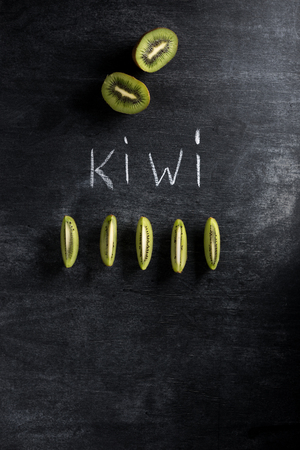 Top view image of kiwi over dark chalkboard backgroundの写真素材