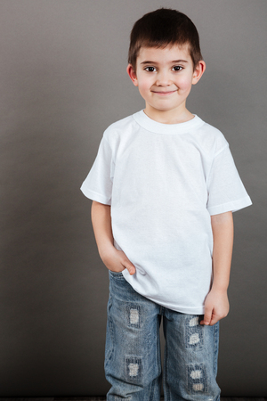 Portrait of happy little boy in white t-shirt and jeansの写真素材