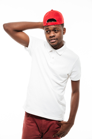 Image of cheerful young african man wearing cap isolated over white background. Looking at camera.の写真素材