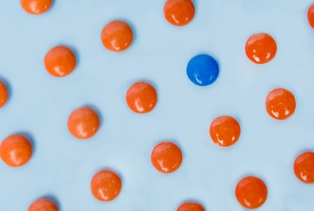 Picture of a lot of colorful sweeties candy over blue table background.