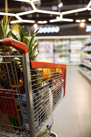 Picture of a lot of fruits in shopping trolley in supermarket.の写真素材