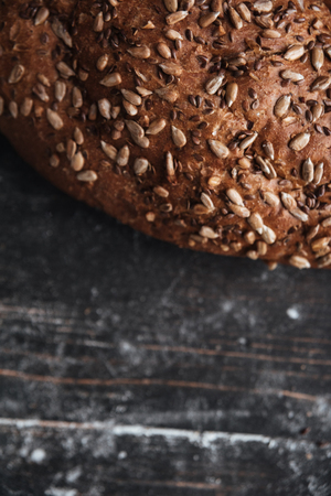 Photo of bread on dark wooden table at bakery