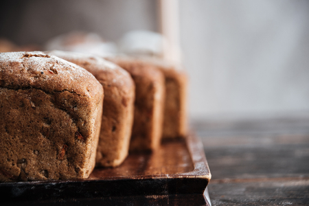 Image of bread with flour on dark wooden table background at bakeryの写真素材