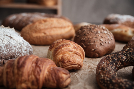 Photo of pastries and bread with flour on table at bakeryの写真素材