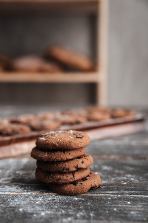 Image of cookies on desk on dark wooden table at bakeryの写真素材