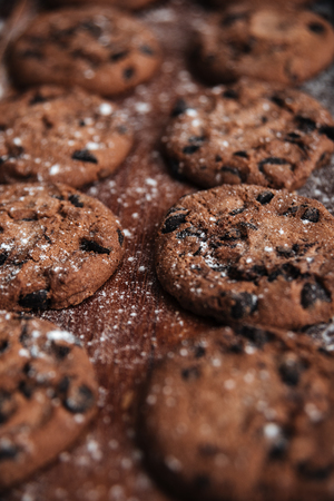 Image of cookies on desk on dark wooden table at bakeryの写真素材